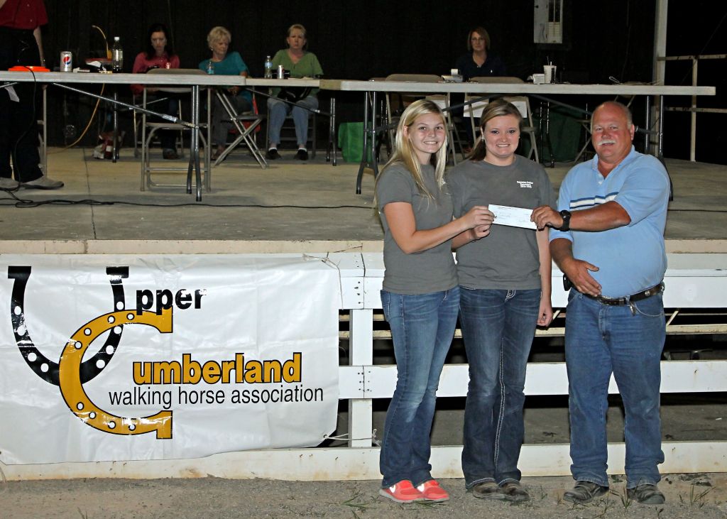 Gary Stidham, UCWHA Show Manager, presents check to Dekalb FFA members Jackie Overbey, Chapter President and Rayanna Baker, Chapter Secretary.